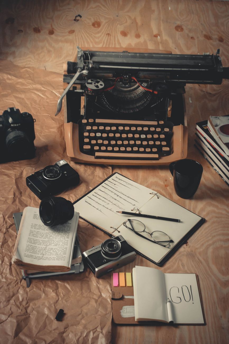 Editor writing in notebook in studio