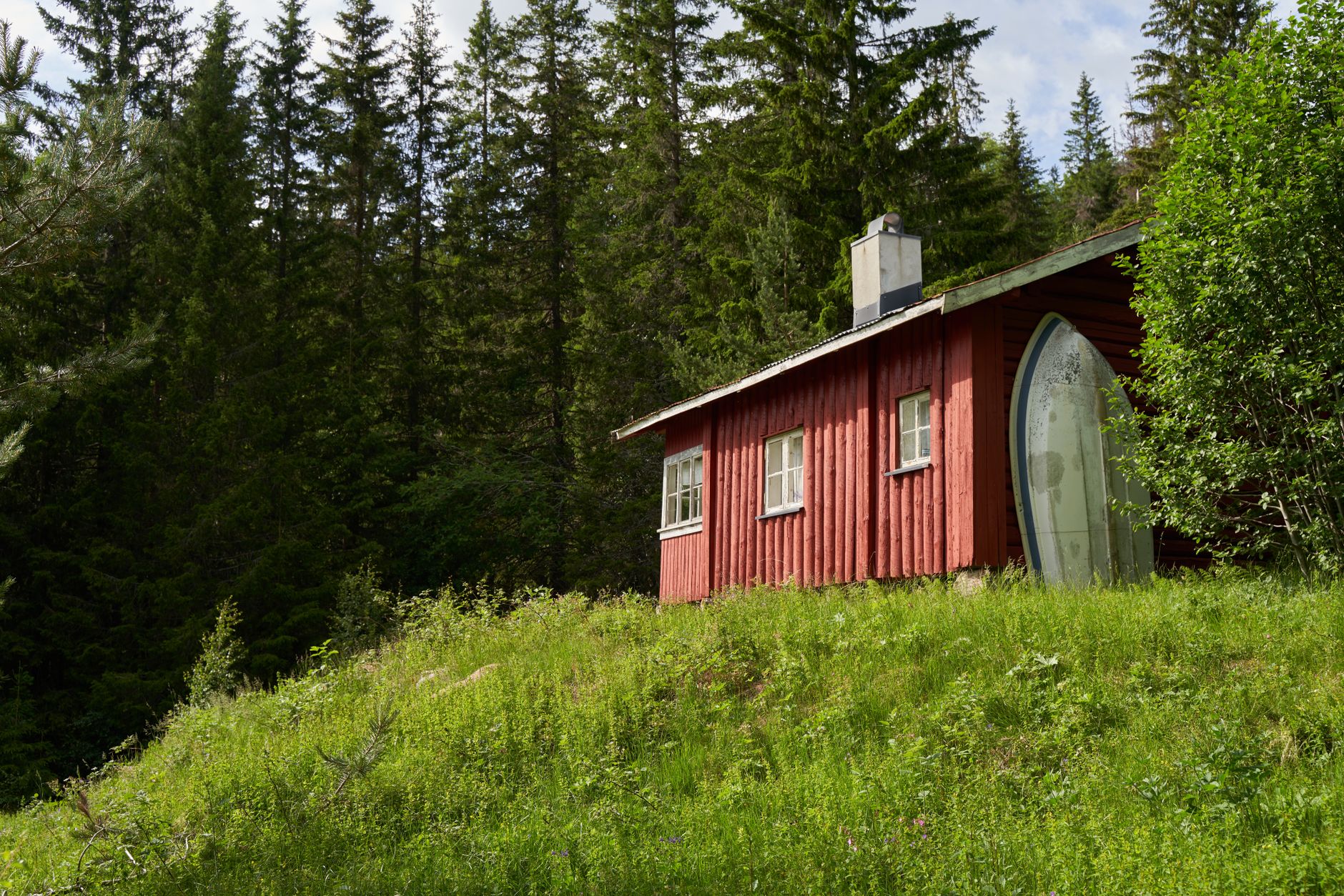 Scandi minimalist timber structure in snow-dusted forest
